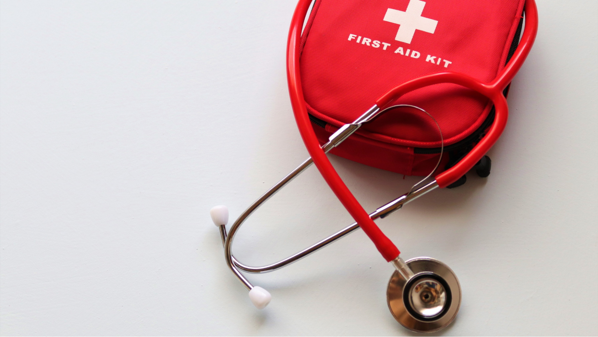 Aerial view of an empty blue Pickleball court on a green surface, casting long shadows. The image conveys a sense of symmetry and calmness.